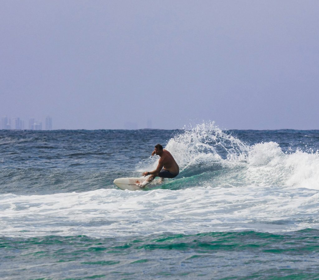 a man riding a wave on top of a surfboard